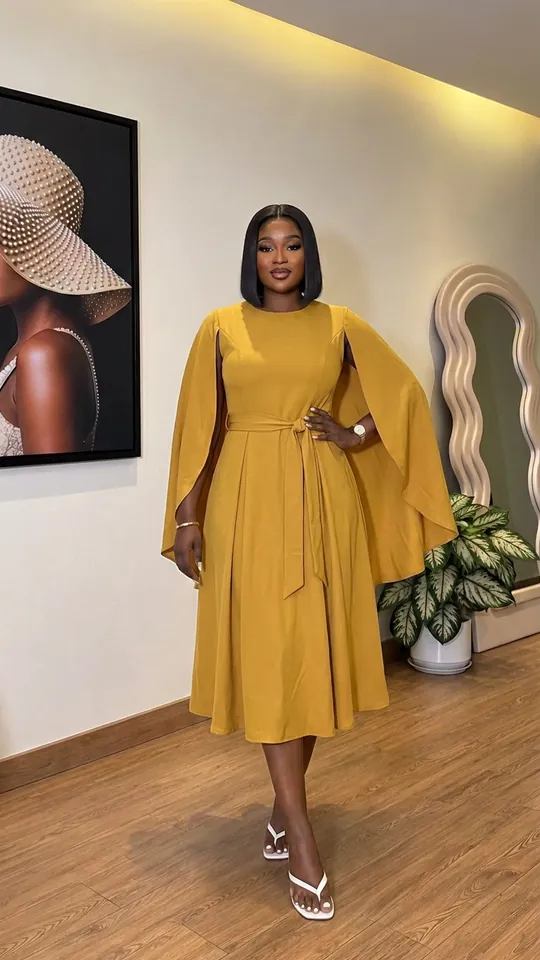 Cape dress in mustard, worn